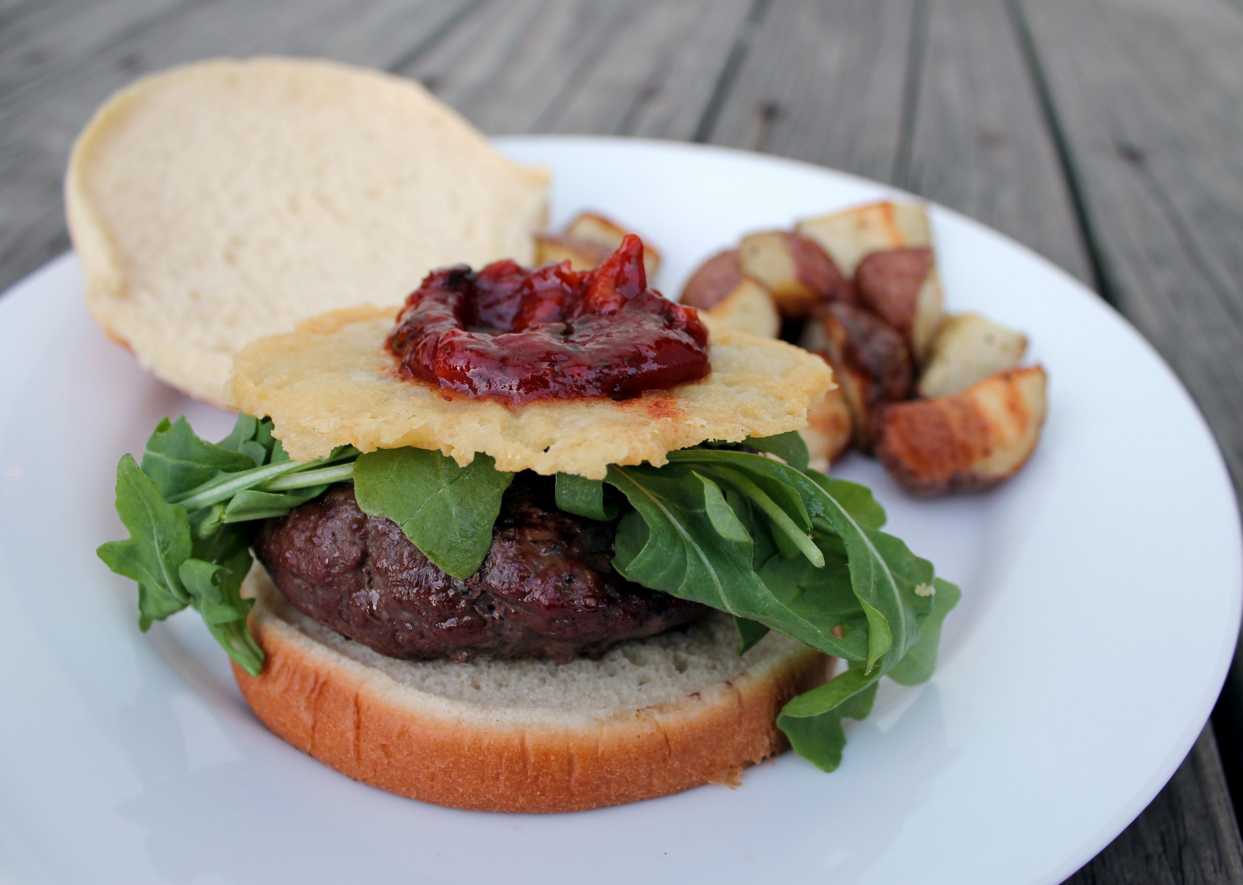 burger with arugula, asagio cheese crisp and spicy basil ketchup Jax
