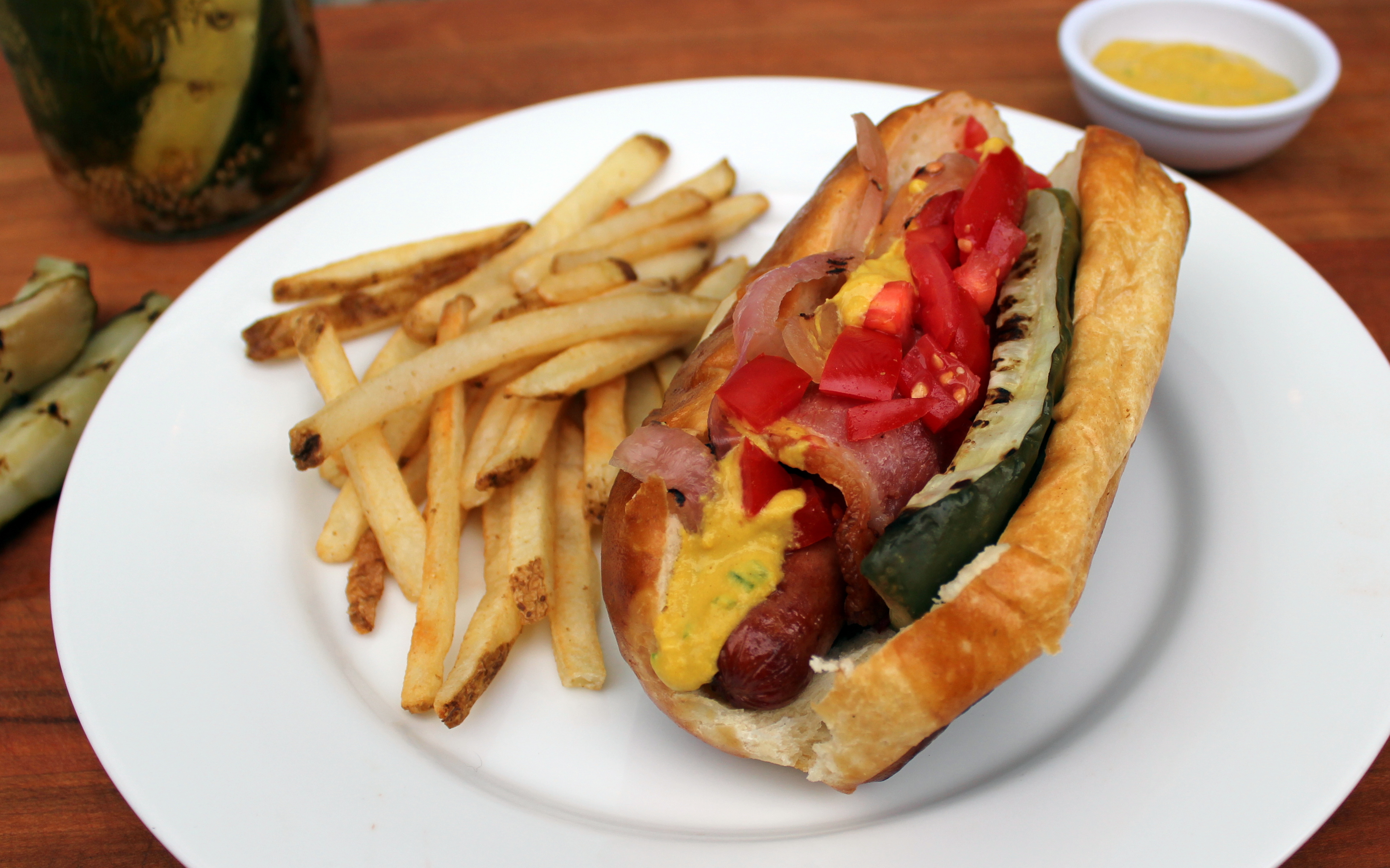 Bacon wrapped hot dog with grilled pickle Jax House