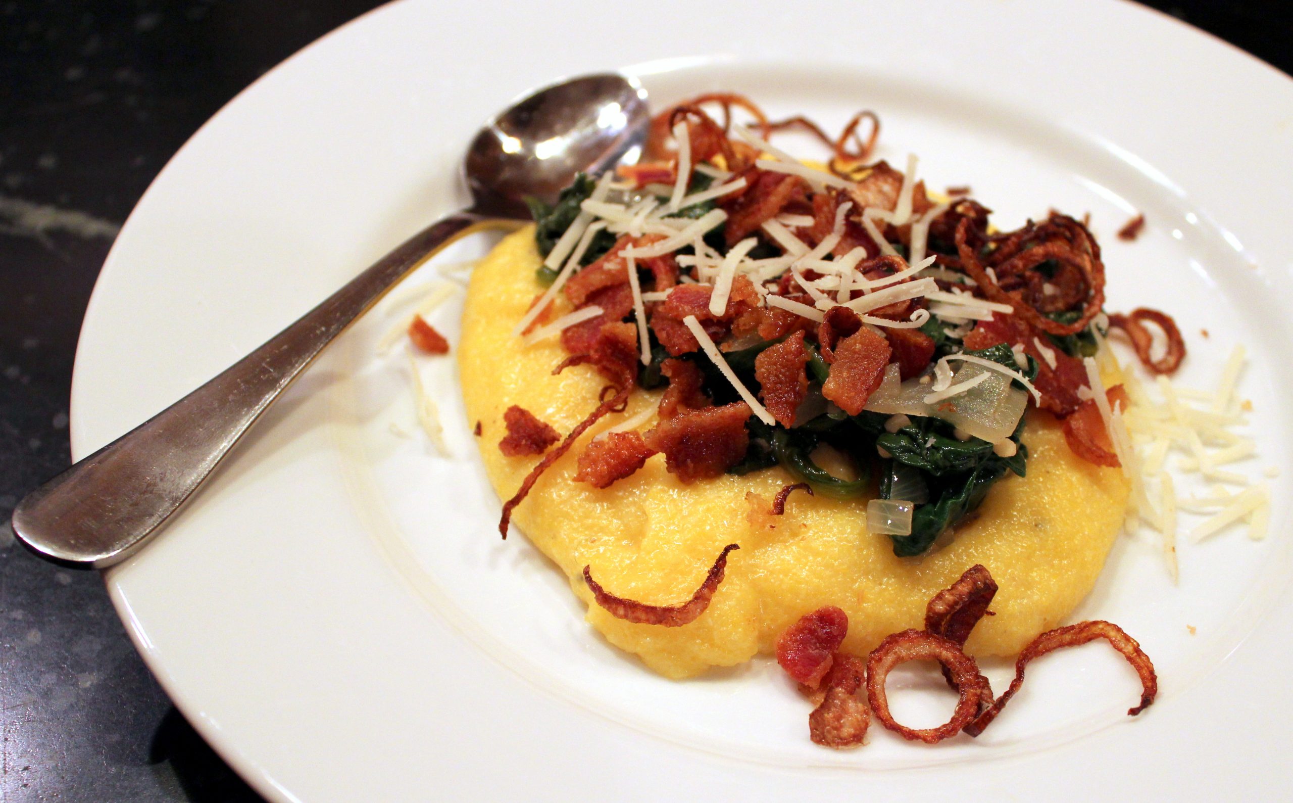 polenta with sauteed spinach and bacon with fried shallots