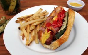 Bacon wrapped hot dog with grilled pickle